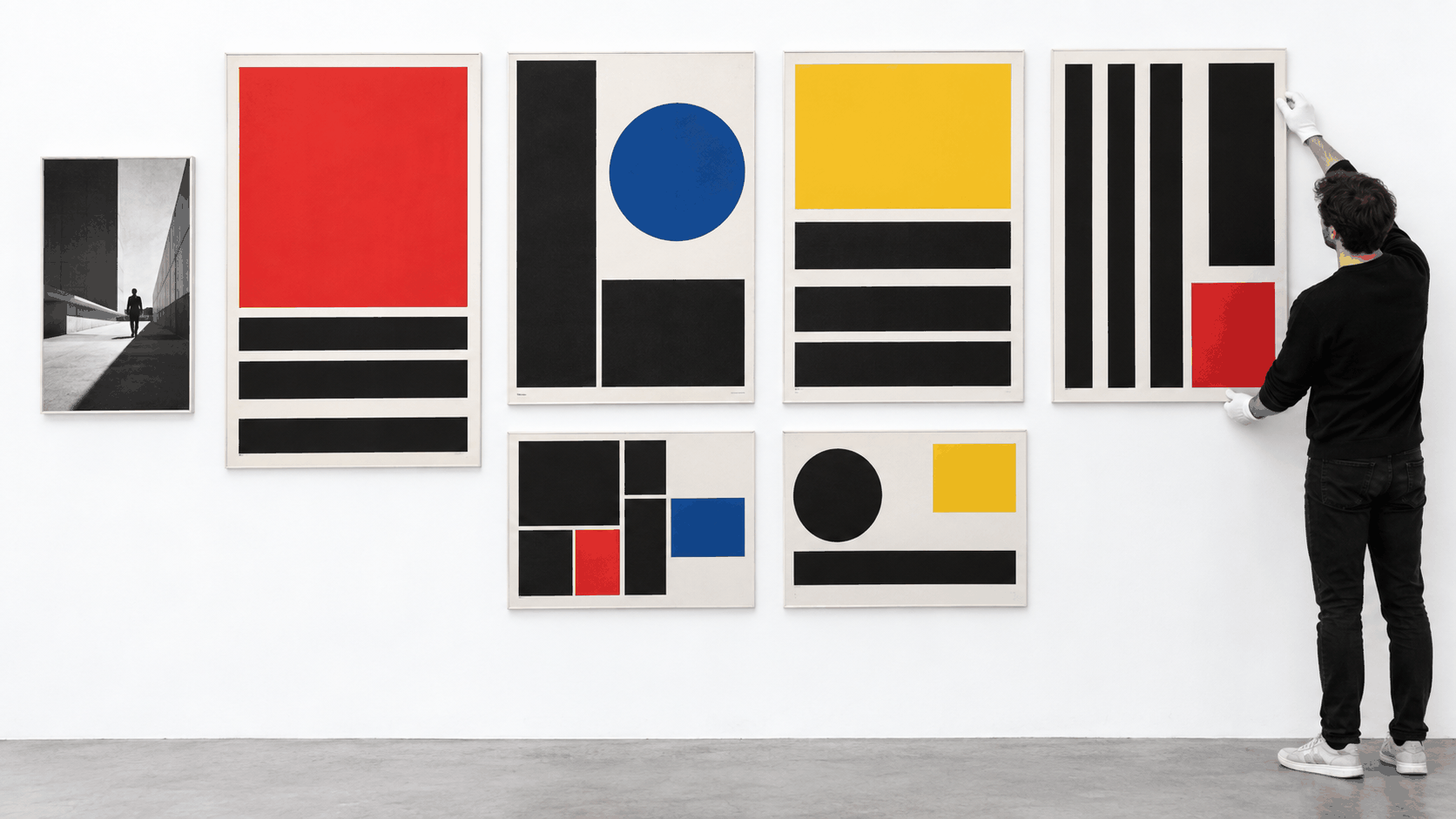 Print designer aligning geometric Swiss Style poster compositions